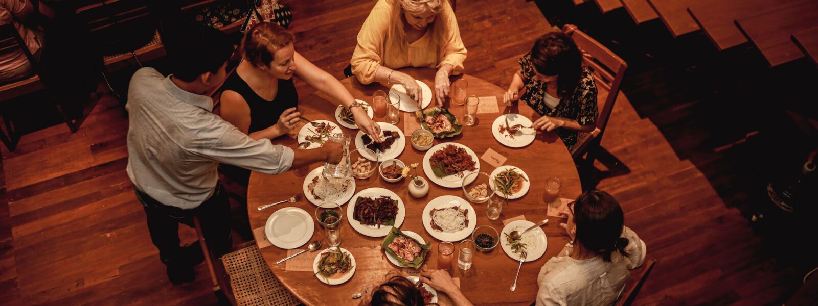 Man serves table at Sampan's Yangon Supper Club