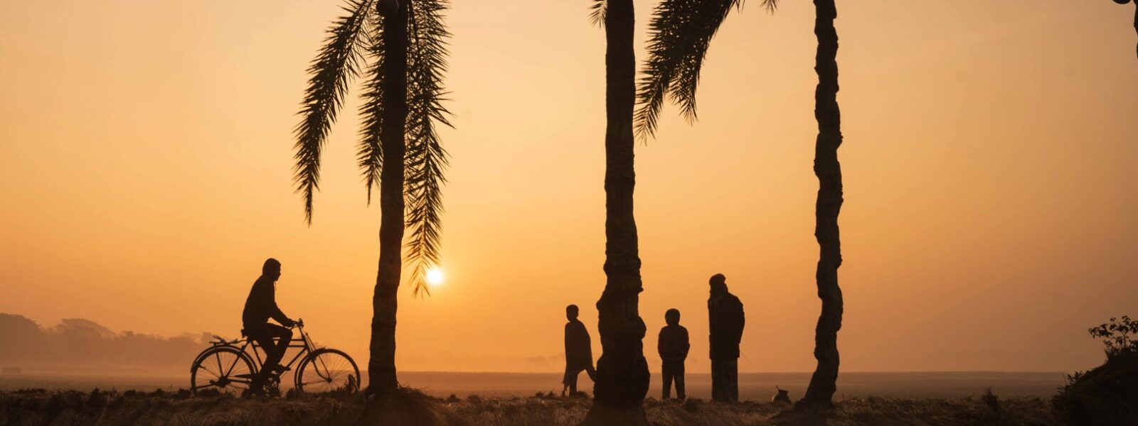 Children and bicycle at sunset in Jessore, Bangladesh